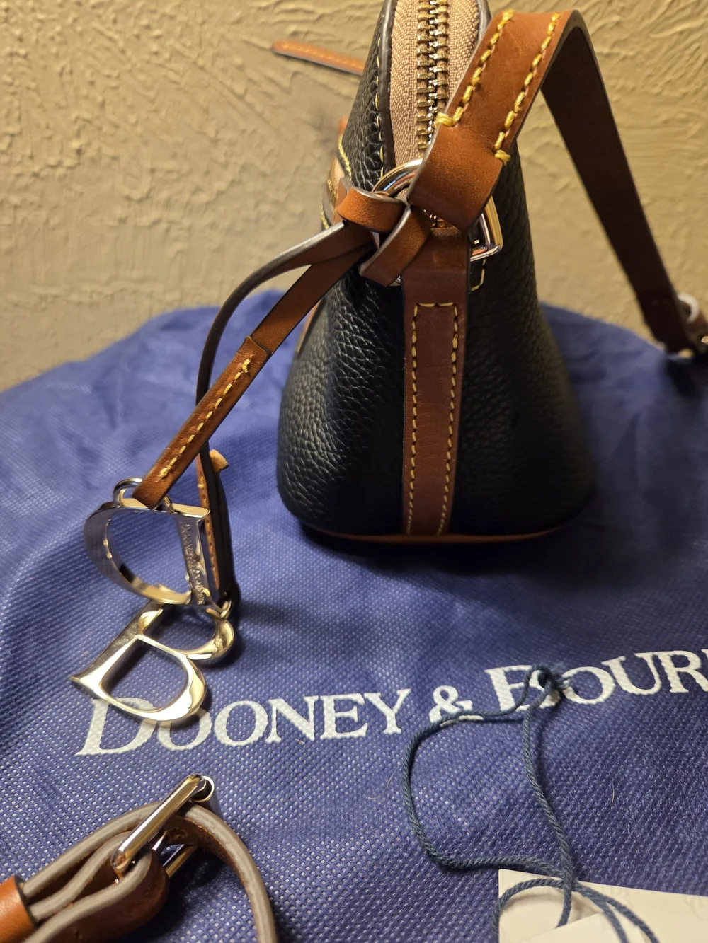 Dooney & Bourke NWT Black Pebble Leather Crossbody with Brown Trim. Logo charms